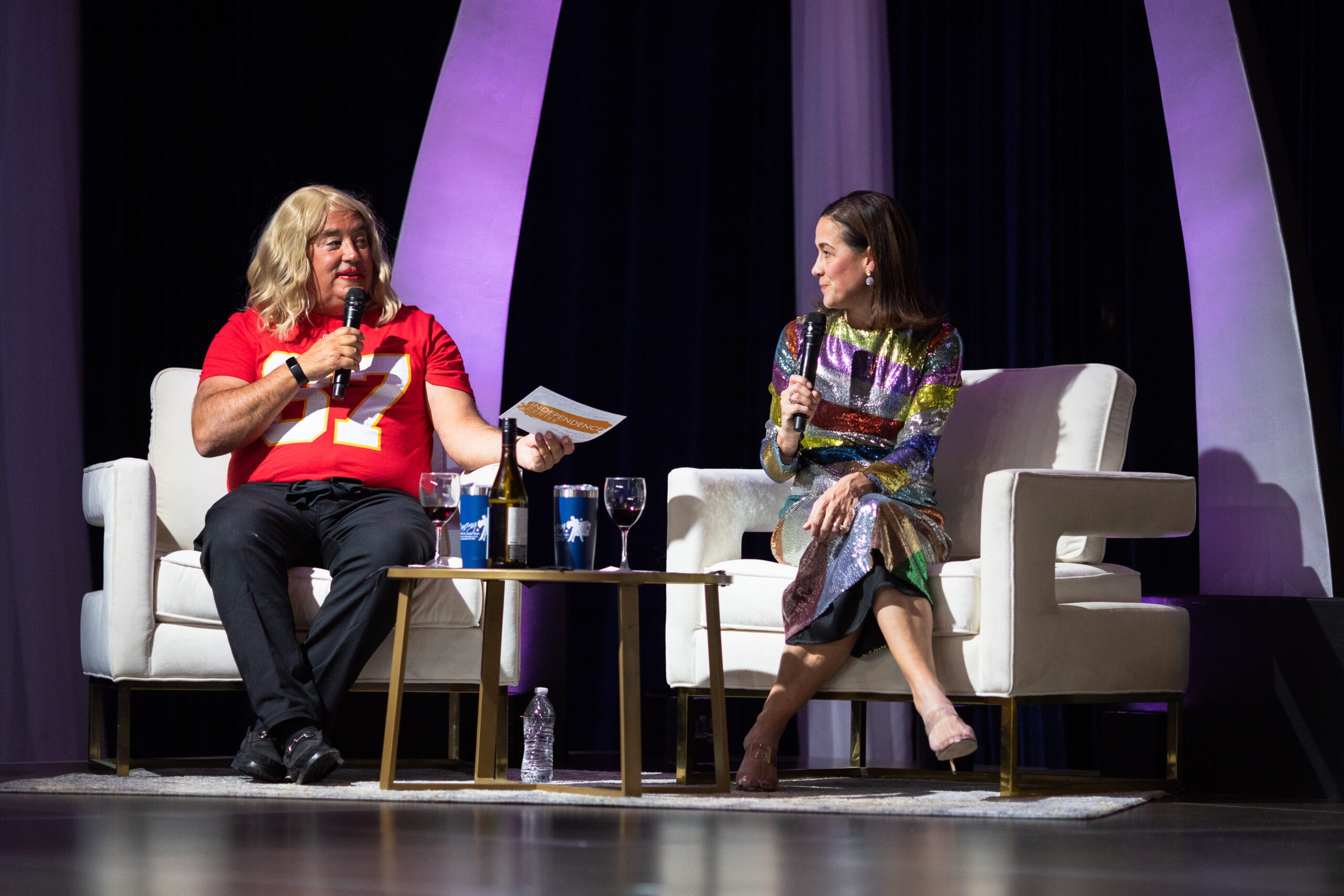 Image of two judges of Dancing with the St. Louis Stars 2024 looking at each other and talking into microphones while sitting in chairs